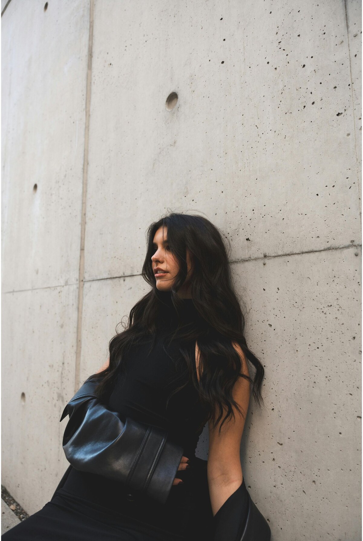Long dark waves against a concrete wall